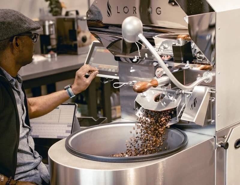 Loring Smart Roaster dropping freshly roasted coffee beans into the cooling tray